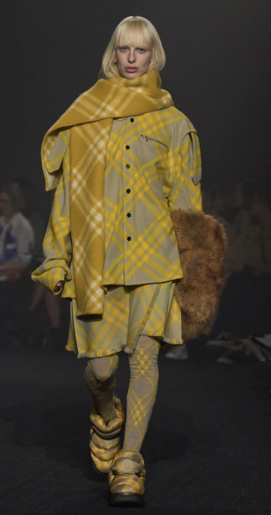 Fall-Winter 2023 Runway look from Burberry. Model wears full tartan pattern outfit from head to toe.
